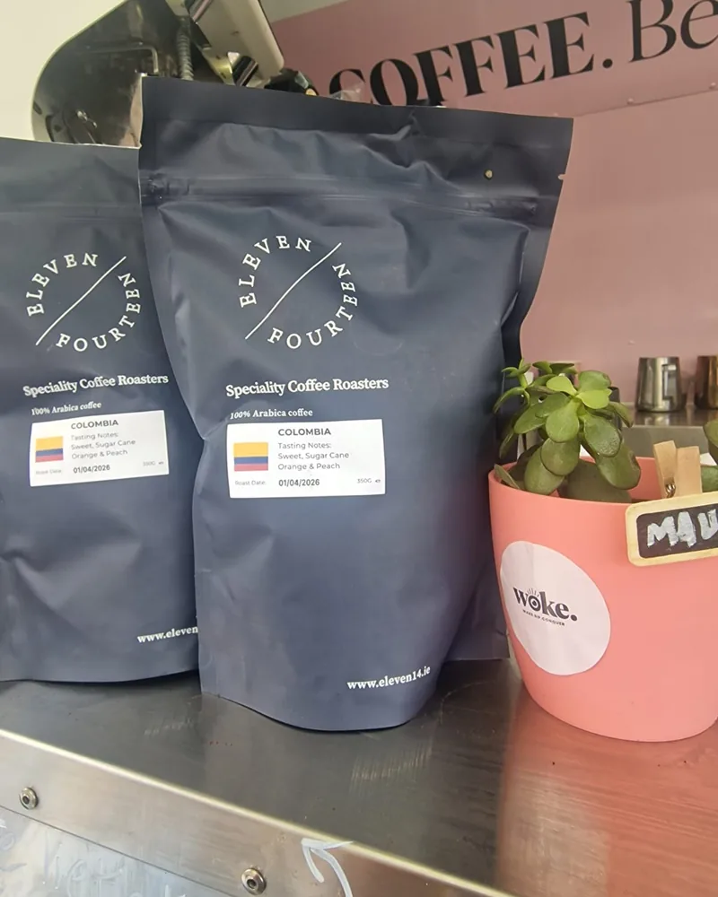 Bags of Eleven Fourteen speciality Colombian coffee on the Woke counter