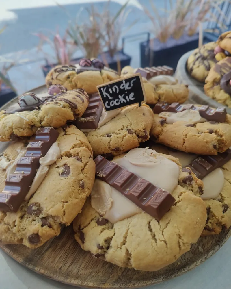 Kinder, Biscoff and white chocolate cookies on a board